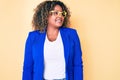 Young african american plus size woman wearing business jacket and glasses looking to side, relax profile pose with natural face Royalty Free Stock Photo