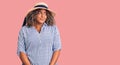 Young african american plus size woman wearing summer hat smiling looking to the side and staring away thinking Royalty Free Stock Photo