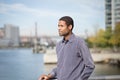 Young African American with the river and bridge in the background Royalty Free Stock Photo