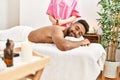 Young african american smiling happy reciving back massage at beauty center Royalty Free Stock Photo