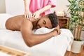 Young african american smiling happy reciving back massage at beauty center Royalty Free Stock Photo