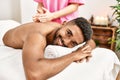 Young african american smiling happy reciving back massage at beauty center Royalty Free Stock Photo