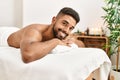 Young african american smiling happy relaxed lying on massage table at beauty center Royalty Free Stock Photo