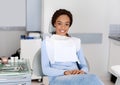 Young african lady sitting at dentist chair, waiting for doctor Royalty Free Stock Photo