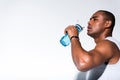 young african american sportsman drinking water from sports bottle
