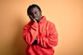 Young african american sporty man wearing sweatshirt with hoodie over yellow background thinking looking tired and bored with Royalty Free Stock Photo