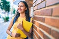 Young african american student girl smiling happy holding book at university campus Royalty Free Stock Photo