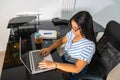 Young African-American student studying at a distance using online continuing education courses and sitting at a table with Royalty Free Stock Photo