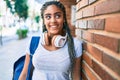 Young african american student woman smiling happy leaning on the wall at the university campus Royalty Free Stock Photo