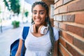 Young african american student woman smiling happy leaning on the wall at the university campus Royalty Free Stock Photo