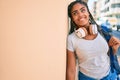 Young african american student woman smiling happy leaning on the wall at the university campus Royalty Free Stock Photo