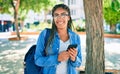 Young african american student woman smiling happy using smartphone at the university campus Royalty Free Stock Photo