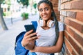 Young african american student woman smiling happy using smartphone at the university campus Royalty Free Stock Photo