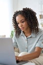 Young African American teen girl watching online videos using laptop at home. Royalty Free Stock Photo