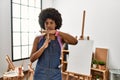 Young african american woman with afro hair at art studio doing time out gesture with hands, frustrated and serious face Royalty Free Stock Photo