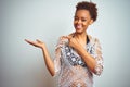 Young african american woman with afro hair wearing a bikini over white isolated background amazed and smiling to the camera while Royalty Free Stock Photo