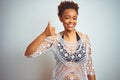 Young african american woman with afro hair wearing a bikini over white isolated background doing happy thumbs up gesture with Royalty Free Stock Photo