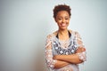 Young african american woman with afro hair wearing a bikini over white isolated background happy face smiling with crossed arms Royalty Free Stock Photo