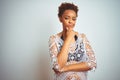 Young african american woman with afro hair wearing a bikini over white isolated background looking confident at the camera with Royalty Free Stock Photo