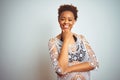 Young african american woman with afro hair wearing a bikini over white isolated background looking confident at the camera Royalty Free Stock Photo