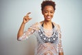 Young african american woman with afro hair wearing a bikini over white isolated background smiling and confident gesturing with Royalty Free Stock Photo