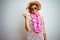 Young african american woman with afro hair wearing flower hawaiian lei over isolated background smiling with happy face looking Royalty Free Stock Photo