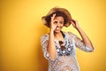 Young african american woman with afro hair wearing summer hat over white isolated background doing ok gesture with hand smiling, Royalty Free Stock Photo