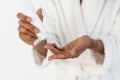 Young african american woman applying moisturizing hand cream Royalty Free Stock Photo