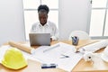 Young african american woman architect using laptop working at architecture studio Royalty Free Stock Photo