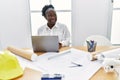 Young african american woman architect using laptop working at architecture studio Royalty Free Stock Photo