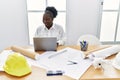 Young african american woman architect using laptop working at architecture studio Royalty Free Stock Photo