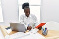 Young african american woman architect using touchpad writing on notebook at architecture studio Royalty Free Stock Photo