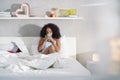 Woman Drinking Coffee Watching Movie In Bed on Sunday Royalty Free Stock Photo