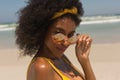 Young African American woman in bikini looking over sunglasses Royalty Free Stock Photo