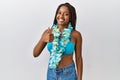 Young african american woman with braids wearing bikini and hawaiian lei doing happy thumbs up gesture with hand Royalty Free Stock Photo