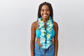 Young african american woman with braids wearing bikini and hawaiian lei with a happy and cool smile on face Royalty Free Stock Photo