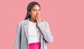 Young african american woman with braids wearing business clothes bored yawning tired covering mouth with hand Royalty Free Stock Photo