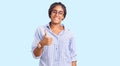 Young african american woman with braids wearing casual clothes and glasses doing happy thumbs up gesture with hand Royalty Free Stock Photo