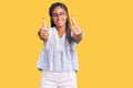 Young african american woman with braids wearing casual summer clothes and glasses approving doing positive gesture with hand, Royalty Free Stock Photo