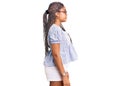 Young african american woman with braids wearing casual summer clothes and glasses looking to side, relax profile pose with Royalty Free Stock Photo