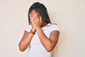Young african american woman with braids wearing casual white tshirt with sad expression covering face with hands while crying Royalty Free Stock Photo