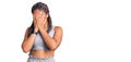 Young african american woman with braids wearing sportswear with sad expression covering face with hands while crying Royalty Free Stock Photo