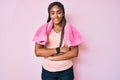 Young african american woman with braids wearing sportswear and towel happy face smiling with crossed arms looking at the camera Royalty Free Stock Photo