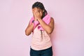 Young african american woman with braids wearing sportswear and towel with sad expression covering face with hands while crying Royalty Free Stock Photo