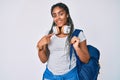 Young african american woman with braids wearing student backpack and headphones smiling happy pointing with hand and finger Royalty Free Stock Photo