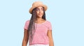 Young african american woman with braids wearing summer hat smiling looking to the side and staring away thinking Royalty Free Stock Photo