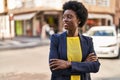 Young african american woman business executive standing with arms crossed gesture at street Royalty Free Stock Photo