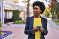Young african american woman business executive using smartphone at park Royalty Free Stock Photo