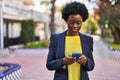Young african american woman business executive using smartphone at park Royalty Free Stock Photo