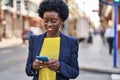 Young african american woman business executive using smartphone at street Royalty Free Stock Photo